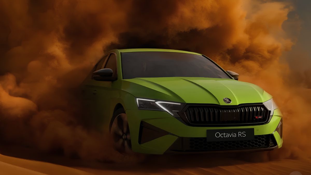 Green Škoda Octavia RS sports sedan driving through dramatic orange smoke